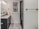 Well-lit bathroom showcasing a marble countertop with a black vanity and a glass shower at 109 Carolina Blvd, Isle of Palms, SC 29451