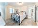 Bright bedroom with a wrought iron bed frame, neutral rug, and window with wooden blinds at 109 Carolina Blvd, Isle of Palms, SC 29451