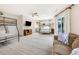 Large, open-concept bedroom features bunkbeds, a tan sofa, and access to an outdoor balcony at 109 Carolina Blvd, Isle of Palms, SC 29451