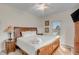 Comfortable bedroom with a ceiling fan, neutral walls, and a large, light-filled window at 109 Carolina Blvd, Isle of Palms, SC 29451