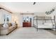 Spacious bedroom with a tan couch, bunkbeds and a large window, bathed in natural light at 109 Carolina Blvd, Isle of Palms, SC 29451