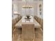 Spacious dining room with large table, seating for twelve, modern chandelier, and bright natural light at 109 Carolina Blvd, Isle of Palms, SC 29451