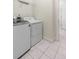 Well-lit laundry area features tiled flooring and modern washer and dryer units at 109 Carolina Blvd, Isle of Palms, SC 29451