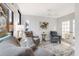 Inviting living room features neutral tones, a decorative ceiling fan, and bright natural light from the large window at 109 Carolina Blvd, Isle of Palms, SC 29451