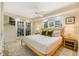 Serene main bedroom with French doors, a plush bed, and bright natural light from the windows at 109 Carolina Blvd, Isle of Palms, SC 29451