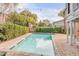Inviting backyard pool area with brick pavers, string lights, palm trees, and landscaping at 109 Carolina Blvd, Isle of Palms, SC 29451