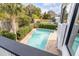 Backyard pool area enclosed with landscaping, brick pavers, and fencing at 109 Carolina Blvd, Isle of Palms, SC 29451