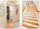 Bright staircase featuring wood treads, white risers and railings, leading to the upper level at 109 Carolina Blvd, Isle of Palms, SC 29451