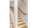 Staircase with wooden steps and white banister with decoratively trimmed support columns at 109 Carolina Blvd, Isle of Palms, SC 29451