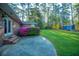 Backyard featuring patio, colorful bush, storage shed, and wooded area at 112 Furlong Rd, Summerville, SC 29483