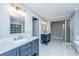 Modern bathroom featuring double vanities with marble countertops, stylish lighting, and a glass-enclosed shower at 112 Furlong Rd, Summerville, SC 29483