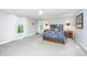 Spacious bedroom featuring neutral walls, plush carpeting, a ceiling fan, and large windows for natural light at 112 Furlong Rd, Summerville, SC 29483