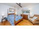 Cozy bedroom featuring a four-poster bed, hardwood floors, and a comfortable wicker chair, offering a relaxing retreat at 112 Furlong Rd, Summerville, SC 29483