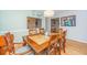 Traditional dining room boasts hardwood floors, ornate wood table and carved chairs, complemented by stylish lighting at 112 Furlong Rd, Summerville, SC 29483