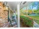 Inviting front porch with rocking chairs, a vintage lantern, and lush plants at 112 Furlong Rd, Summerville, SC 29483