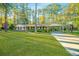 Charming single-story home with a well-manicured front yard, mature trees, and a basketball court at 112 Furlong Rd, Summerville, SC 29483