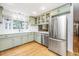 Charming kitchen features stainless steel appliances, ample counter space, and stylish green cabinetry at 112 Furlong Rd, Summerville, SC 29483