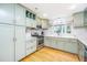 Well-appointed kitchen featuring stainless steel appliances, quartz countertops and sage green cabinetry at 112 Furlong Rd, Summerville, SC 29483