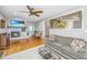 Comfortable living room with hardwood floors, gray sofa, and open view to the kitchen at 112 Furlong Rd, Summerville, SC 29483