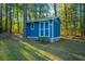 Storage shed with stairs, double doors, and surrounding trees at 112 Furlong Rd, Summerville, SC 29483