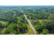 Areal view features the house and landscape, nestled within a dense, vibrant green forest at 11341 Cottageville Hwy, Cottageville, SC 29435