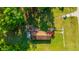 Aerial shot of home, showcasing its roof, lawn, and surrounding trees at 11341 Cottageville Hwy, Cottageville, SC 29435
