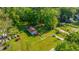 Aerial view showcases the house and its surroundings with lush greenery and neighborhood features at 11341 Cottageville Hwy, Cottageville, SC 29435