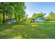 Spacious backyard featuring a shed, lush lawn, and mature trees, perfect for outdoor activities at 11341 Cottageville Hwy, Cottageville, SC 29435