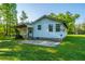 Backyard view with a covered patio and lush green grass at 11341 Cottageville Hwy, Cottageville, SC 29435