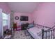 Comfortable bedroom with pink walls, an iron bed, and a window with natural light at 11341 Cottageville Hwy, Cottageville, SC 29435
