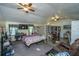 Spacious bedroom with multiple beds, ceiling fan, desk area, and stone accent wall at 11341 Cottageville Hwy, Cottageville, SC 29435