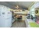 Galley-style kitchen with white appliances, light wood flooring, and plenty of storage at 11341 Cottageville Hwy, Cottageville, SC 29435