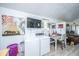 Bright living area featuring a dining area, washer and dryer, and a television at 11341 Cottageville Hwy, Cottageville, SC 29435
