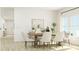 Bright dining room with a rustic wood table, stylish chairs, and large windows at 1157 Darling St, Summerville, SC 29485