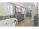 Luxurious bathroom featuring double vanities, a soaking tub, and a separate glass shower at 12 Trail Hollow Ct, Charleston, SC 29414