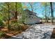 A view of the home's garage, side yard with flowering bushes, and basketball hoop at 12 Trail Hollow Ct, Charleston, SC 29414