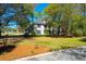 Charming two-story home with landscaped yard, mature trees, and a welcoming front porch at 12 Trail Hollow Ct, Charleston, SC 29414