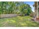 Spacious backyard with wood privacy fence, mature trees, and well-maintained lawn at 1215 Dingle Rd, Mount Pleasant, SC 29466