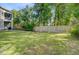 Large fenced backyard with a lush lawn, shaded by mature trees, offering a private retreat at 1215 Dingle Rd, Mount Pleasant, SC 29466
