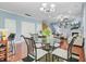 Charming dining room with hardwood floors, round glass table, and views into the adjacent living space at 1215 Dingle Rd, Mount Pleasant, SC 29466