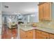 Open-concept space with kitchen bar overlooking living room with fireplace and hardwood floors at 1215 Dingle Rd, Mount Pleasant, SC 29466