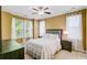 Cozy bedroom features neutral tones, large windows, a ceiling fan, and plush carpeting at 1215 Dingle Rd, Mount Pleasant, SC 29466
