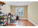 Bright home office with hardwood floors, dual windows, and a white desk chair at 1215 Dingle Rd, Mount Pleasant, SC 29466