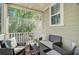 Relaxing screened-in porch with comfortable seating, ceiling fan, and views of the lush backyard at 1215 Dingle Rd, Mount Pleasant, SC 29466
