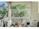 Comfortable screened-in porch with cozy seating and scenic views of the surrounding greenery at 1215 Dingle Rd, Mount Pleasant, SC 29466