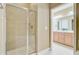 Walk-in shower featuring a glass door and tile surround, adjacent to a view of the double sink bathroom at 1215 Dingle Rd, Mount Pleasant, SC 29466