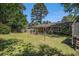 Spacious backyard with a wood pergola, patio and mature trees at 122 William St, Summerville, SC 29486