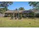 Lush backyard features mature lawn, patio, pergola and beautiful landscaping at 122 William St, Summerville, SC 29486
