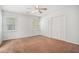 Spacious bedroom with neutral walls, ceiling fan, plush carpeting and bright windows overlooking greenery at 122 William St, Summerville, SC 29486