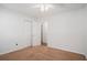 A well-lit bedroom features neutral carpet, a ceiling fan, closet, and a view to another room at 122 William St, Summerville, SC 29486